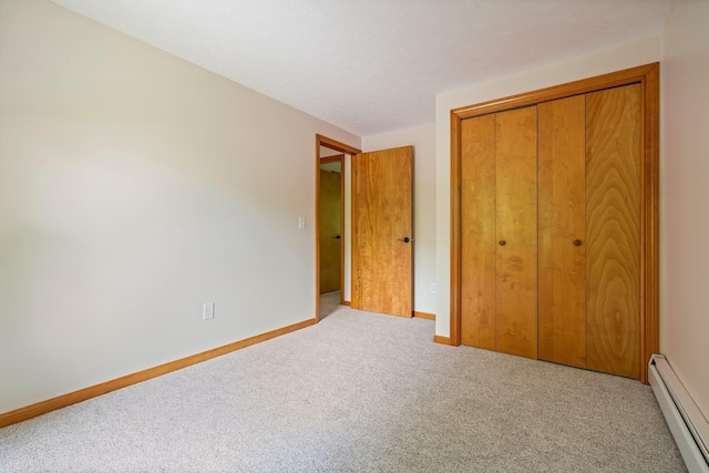40 Trolley St, Manchester, NH 03103 - unfurnished bedroom with baseboard heating, carpet, a closet, and baseboards