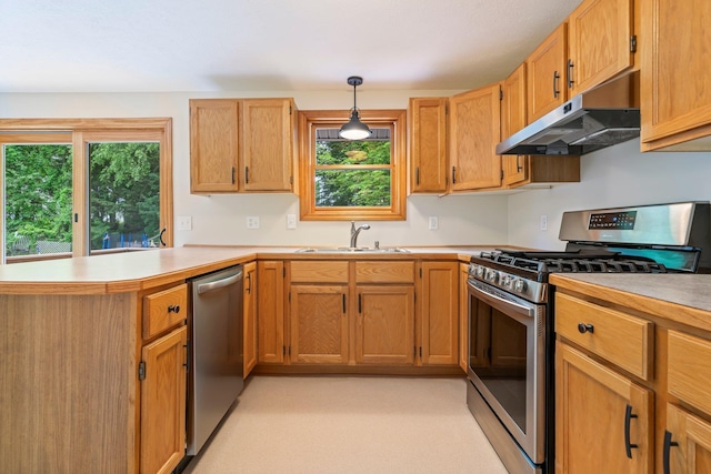 40 Trolley St, Manchester, NH 03103 - kitchen with appliances with stainless steel finishes, under cabinet range hood, a sink, a peninsula, and light countertops