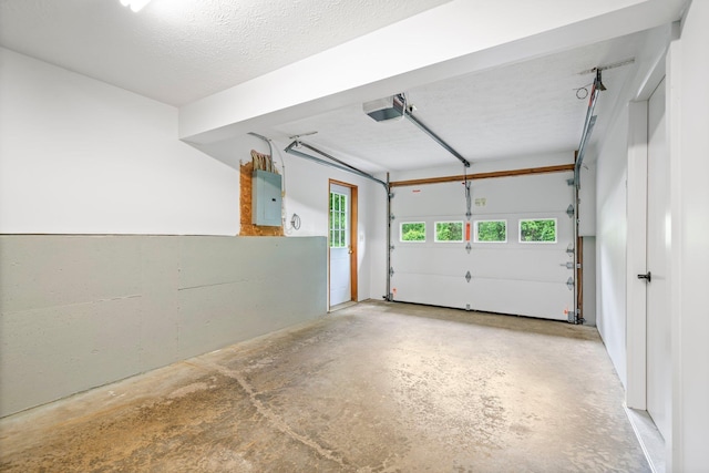 40 Trolley St, Manchester, NH 03103 - garage featuring a garage door opener and electric panel