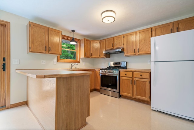 40 Trolley St, Manchester, NH 03103 - kitchen featuring freestanding refrigerator, stainless steel gas range, under cabinet range hood, light countertops, and a sink
