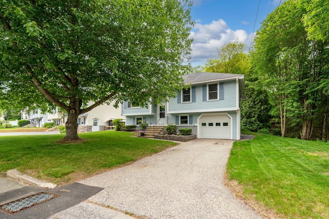 40 Trolley St, Manchester, NH 03103 - split foyer home with a garage, a front yard, and asphalt driveway