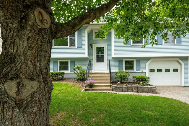 40 Trolley St, Manchester, NH 03103 - raised ranch featuring an attached garage, a front yard, driveway, and entry steps