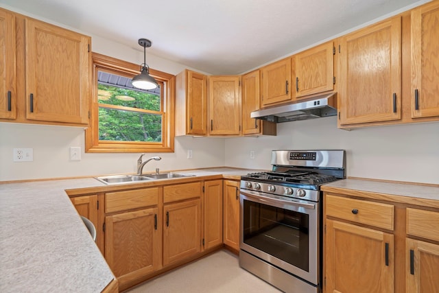 40 Trolley St, Manchester, NH 03103 - kitchen featuring stainless steel gas range, under cabinet range hood, a sink, light countertops, and decorative light fixtures