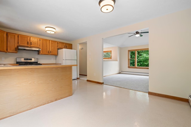40 Trolley St, Manchester, NH 03103 - kitchen featuring stainless steel range, under cabinet range hood, freestanding refrigerator, a baseboard heating unit, and baseboards