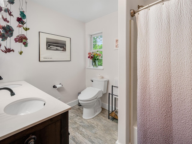 1851 York Street Ext, Poultney, VT 05764 - bathroom with wood finished floors, double vanity, toilet, and baseboards
