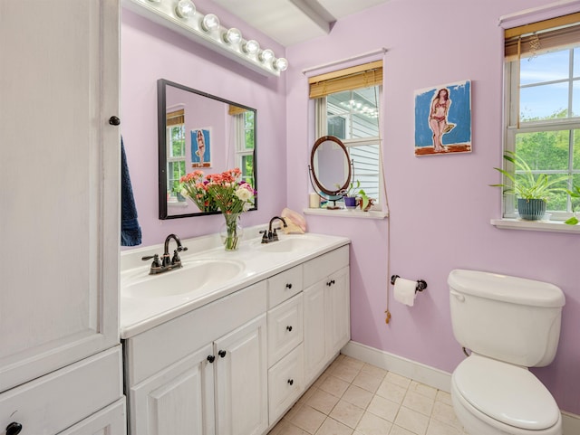 1851 York Street Ext, Poultney, VT 05764 - bathroom featuring double vanity, toilet, baseboards, and tile patterned floors