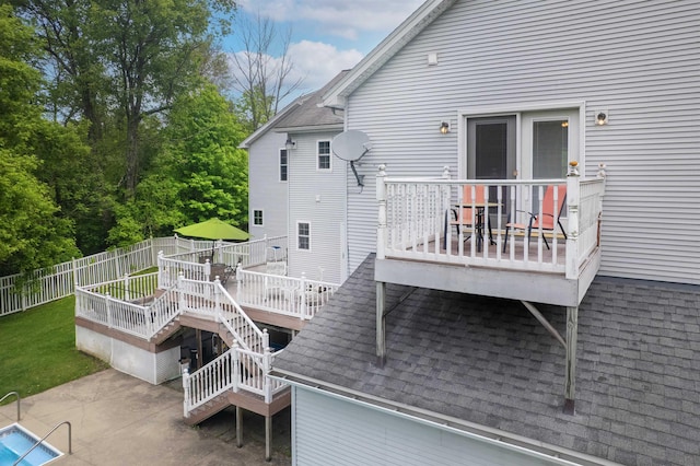 1851 York Street Ext, Poultney, VT 05764 - rear view of house with roof with shingles, a deck, a fenced backyard, a patio area, and stairway