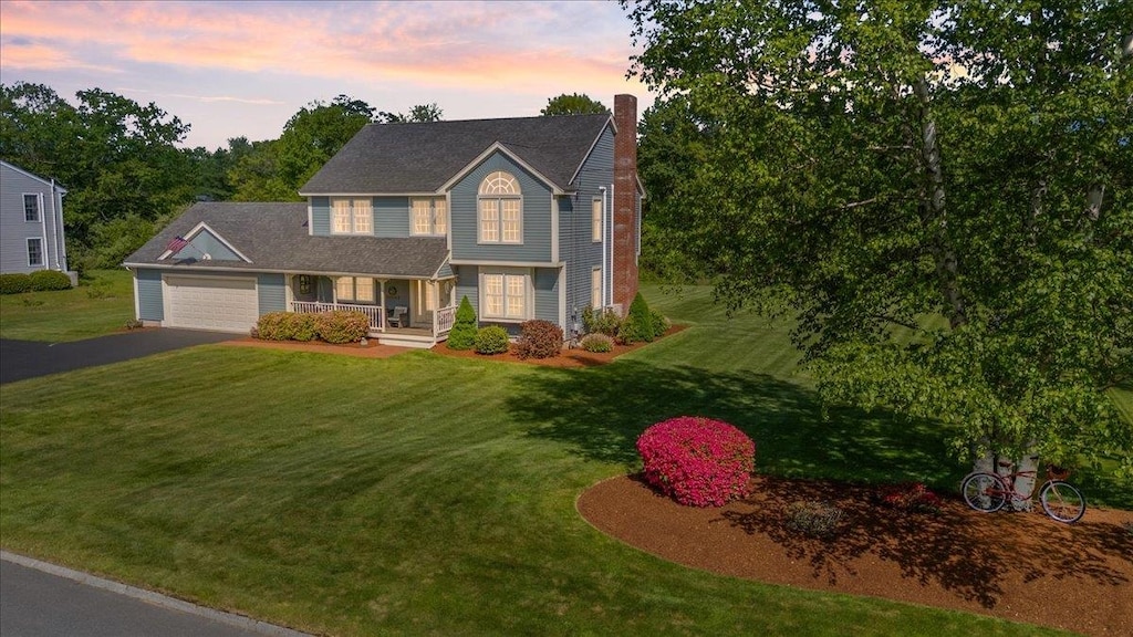 3 Corbin Dr, Dover, NH 03820 - view of front of home with a porch, a chimney, driveway, and a front yard