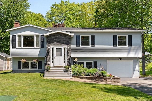 165 Tanglewood Dr, Colchester, VT 05546 - bi-level home featuring an attached garage, driveway, a front lawn, a chimney, and stone siding