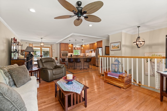 165 Tanglewood Dr, Colchester, VT 05546 - living area with ornamental molding, ceiling fan, light wood-type flooring, recessed lighting, and a chandelier