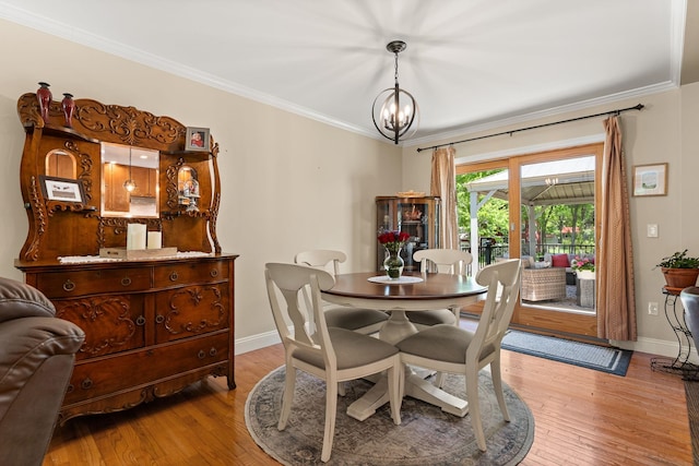 165 Tanglewood Dr, Colchester, VT 05546 - dining area with baseboards, crown molding, hardwood / wood-style floors, and a chandelier