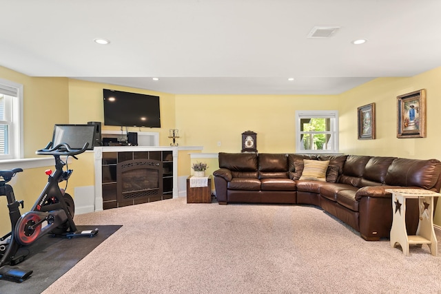 165 Tanglewood Dr, Colchester, VT 05546 - carpeted living room with recessed lighting and a tile fireplace