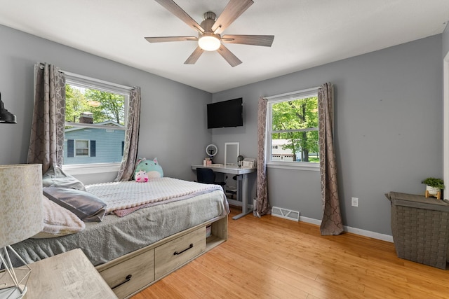 165 Tanglewood Dr, Colchester, VT 05546 - bedroom featuring multiple windows, light wood finished floors, baseboards, and ceiling fan