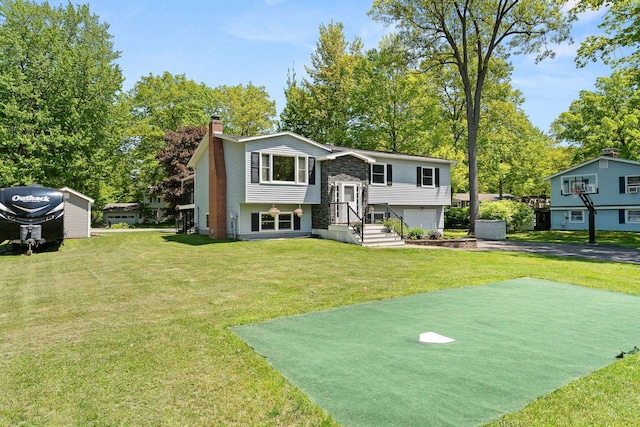165 Tanglewood Dr, Colchester, VT 05546 - raised ranch with driveway, a garage, a chimney, and a front lawn