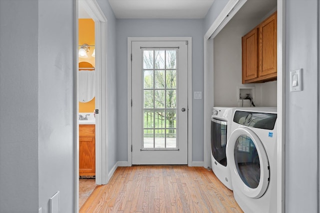 2351 Sugar Hill Rd, Wallingford, VT 05742 - laundry area with cabinet space, light wood-type flooring, separate washer and dryer, and healthy amount of natural light