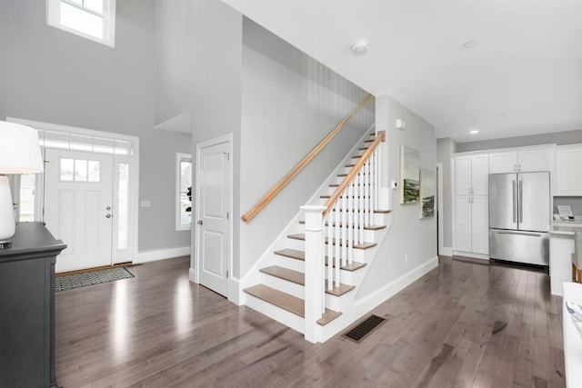 148 County Rd, Amherst, NH 03055 - foyer entrance with wood finished floors, stairway, baseboards, and a high ceiling