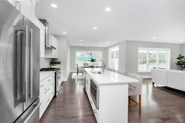 148 County Rd, Amherst, NH 03055 - kitchen with stainless steel appliances, a sink, healthy amount of natural light, a kitchen breakfast bar, and recessed lighting