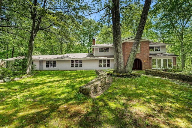 28 Olde Lantern Rd, Bedford, NH 03110 - view of front of property featuring a chimney, a front yard, and brick siding