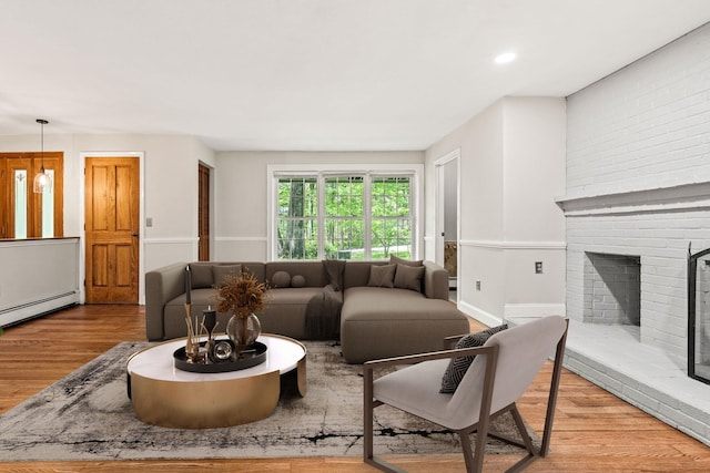 28 Olde Lantern Rd, Bedford, NH 03110 - living room featuring baseboard heating, wood finished floors, and a fireplace