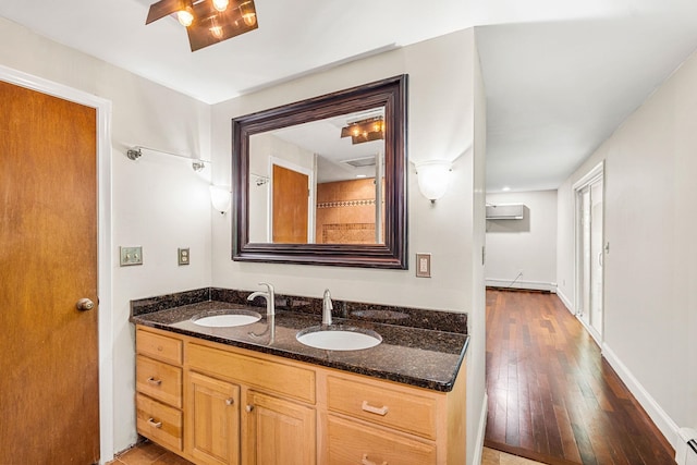 28 Olde Lantern Rd, Bedford, NH 03110 - bathroom with baseboard heating, hardwood / wood-style flooring, double vanity, and a wall unit AC