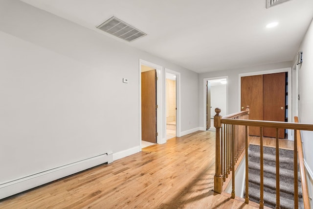 28 Olde Lantern Rd, Bedford, NH 03110 - hallway with a baseboard heating unit, an upstairs landing, light wood-style flooring, baseboards, and recessed lighting
