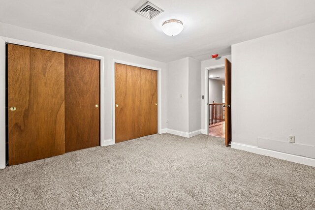 28 Olde Lantern Rd, Bedford, NH 03110 - unfurnished bedroom featuring multiple closets, carpet floors, and baseboards