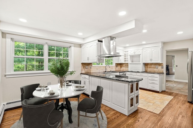 28 Olde Lantern Rd, Bedford, NH 03110 - kitchen with a sink, island exhaust hood, a peninsula, white cabinetry, and recessed lighting