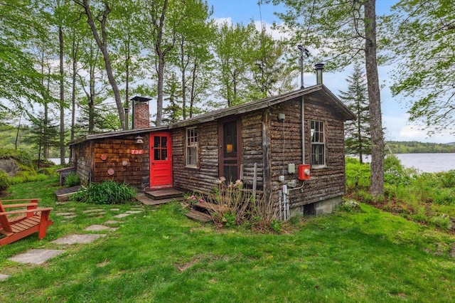 138 Miller Dr, Nelson, NH 03457 - rear view of house featuring a chimney, a lawn, and a water view