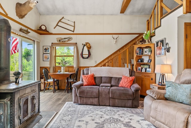 122 Wallace Rd, Northfield, VT 05663 - living area with a wood stove, wood finished floors, stairs, wood walls, and wainscoting