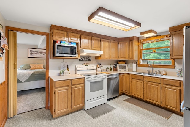 122 Wallace Rd, Northfield, VT 05663 - kitchen with stainless steel appliances, under cabinet range hood, a sink, and light countertops