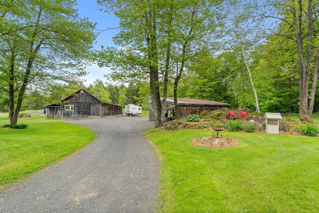 122 Wallace Rd, Northfield, VT 05663 - view of front of house featuring dirt driveway, a barn, a front yard, an outbuilding, and board and batten siding
