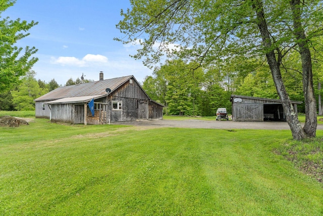 122 Wallace Rd, Northfield, VT 05663 - rear view of property with a yard, an outbuilding, and driveway