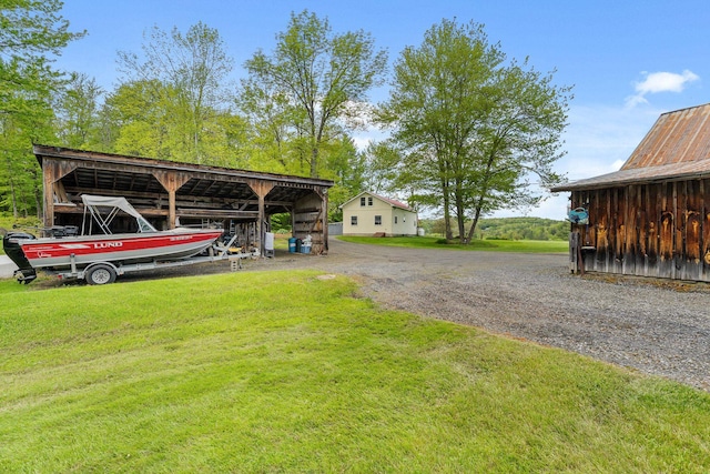 122 Wallace Rd, Northfield, VT 05663 - view of green lawn featuring an outbuilding, driveway, a carport, and an outdoor structure