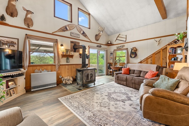 122 Wallace Rd, Northfield, VT 05663 - living area with a wood stove, plenty of natural light, wood finished floors, wooden walls, and high vaulted ceiling