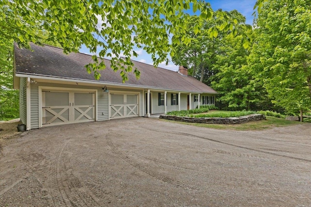 1444 Upper Hollow Rd, Stowe, VT 05672 - view of front of home featuring a chimney, driveway, an attached garage, and a shingled roof