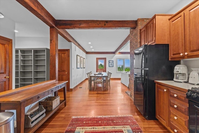 1444 Upper Hollow Rd, Stowe, VT 05672 - kitchen with beam ceiling, light wood-style flooring, black appliances, brown cabinets, and recessed lighting