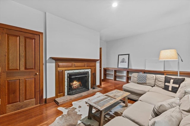 1444 Upper Hollow Rd, Stowe, VT 05672 - living room with wood finished floors, a warm lit fireplace, and baseboards