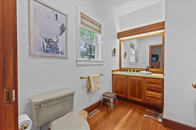 1444 Upper Hollow Rd, Stowe, VT 05672 - half bath with wood finished floors, vanity, toilet, and baseboards