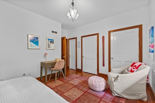 1444 Upper Hollow Rd, Stowe, VT 05672 - bedroom with wood finished floors and a chandelier