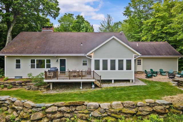1444 Upper Hollow Rd, Stowe, VT 05672 - back of property featuring a wooden deck, a fire pit, a chimney, a lawn, and roof with shingles