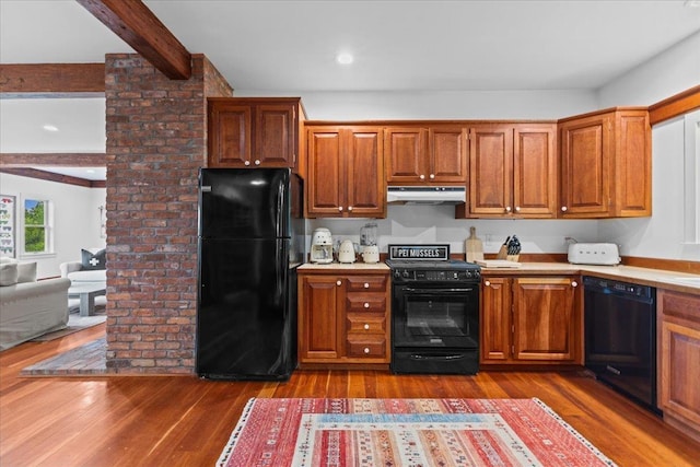 1444 Upper Hollow Rd, Stowe, VT 05672 - kitchen featuring black appliances, under cabinet range hood, light countertops, beamed ceiling, and dark wood-style floors