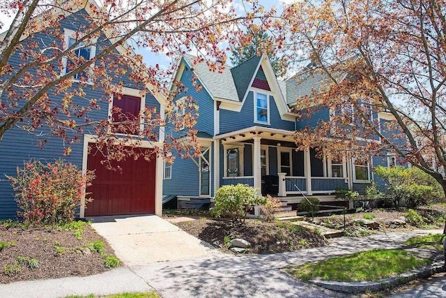 162 Sagamore St, Manchester, NH 03104 - victorian home with covered porch, a garage, and driveway