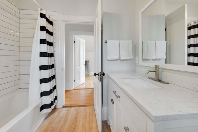 162 Sagamore St, Manchester, NH 03104 - full bath featuring vanity, radiator, wood-type flooring, and shower / bath combination with curtain