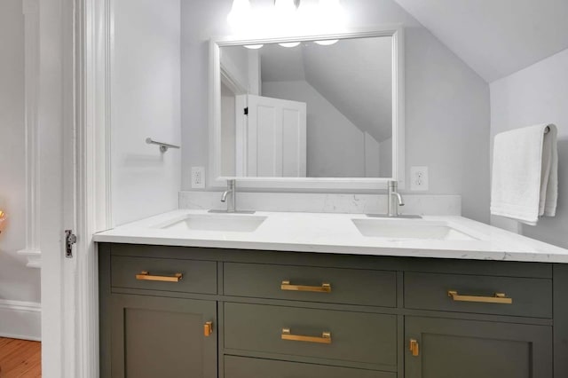162 Sagamore St, Manchester, NH 03104 - full bathroom featuring double vanity, vaulted ceiling, and wood finished floors