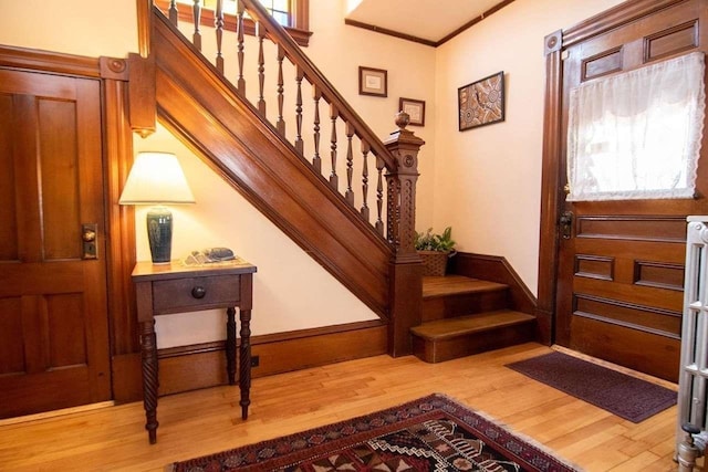 162 Sagamore St, Manchester, NH 03104 - entryway featuring stairs, wood finished floors, crown molding, and baseboards