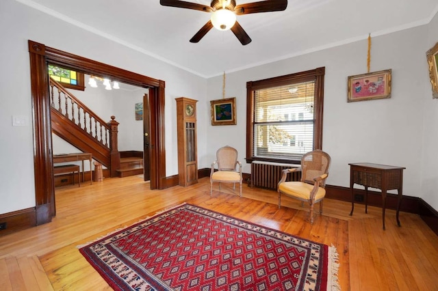 162 Sagamore St, Manchester, NH 03104 - sitting room with wood-type flooring, stairs, radiator, a ceiling fan, and crown molding