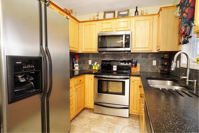 602 Silver St Unit 5, Manchester, NH 03103 - kitchen with appliances with stainless steel finishes, a sink, decorative backsplash, and light brown cabinets