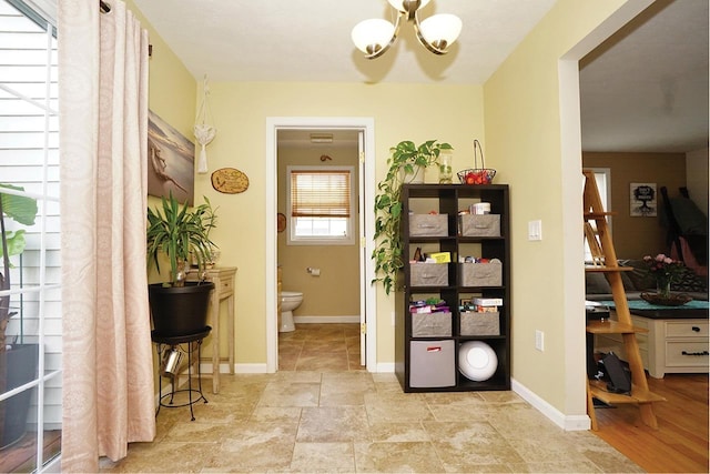 602 Silver St Unit 5, Manchester, NH 03103 - corridor with a chandelier and baseboards