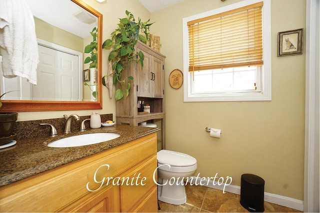 602 Silver St Unit 5, Manchester, NH 03103 - bathroom featuring vanity, toilet, baseboards, and tile patterned flooring