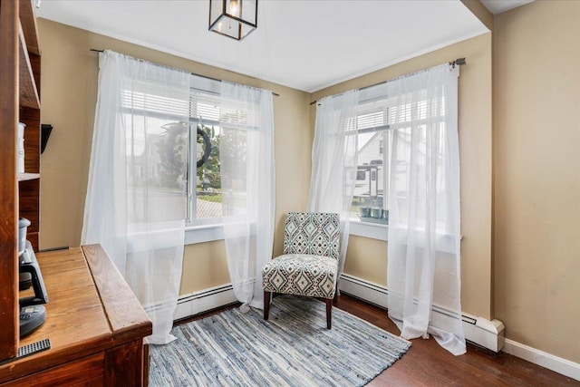 27 Eden St, Goffstown, NH 03102 - sitting room featuring wood finished floors, baseboards, and a baseboard heating unit